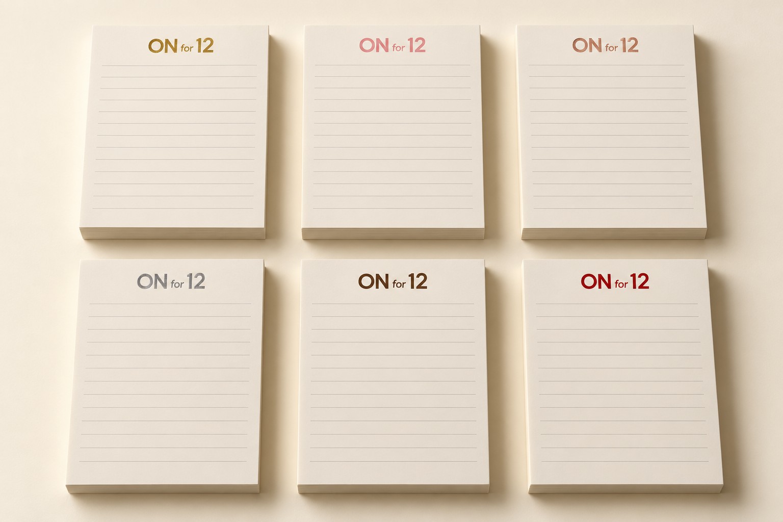 Six ON for 12 logo notepad concepts in gold, pink, rose gold, silver, brown, and red